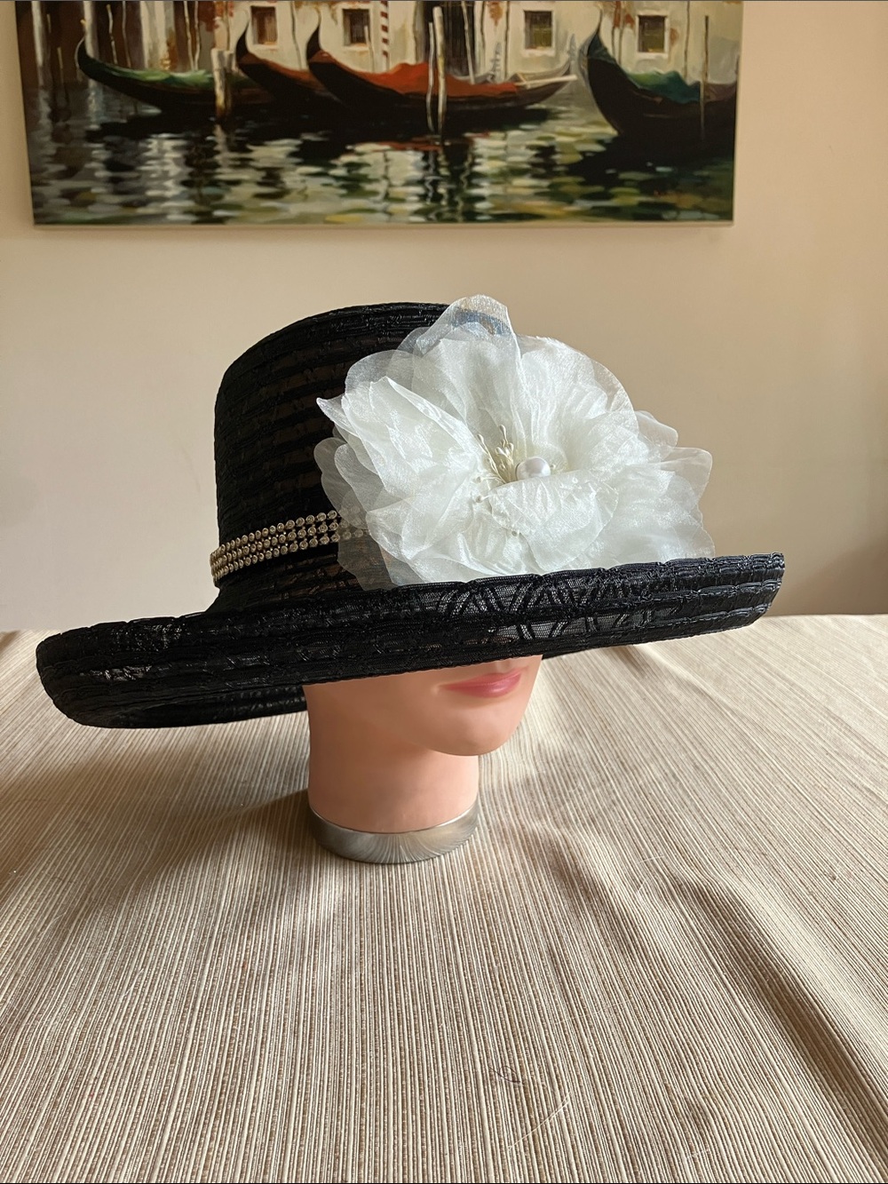 Chic Black Wide-Brim Hat with White Floral Accent and Rhinestone Band